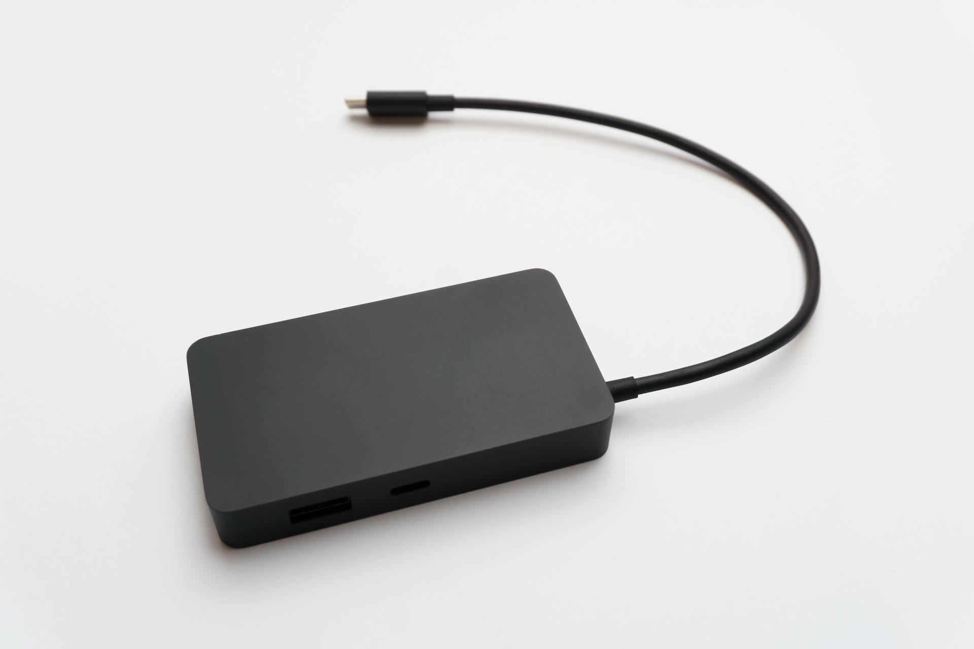 A sleek portable external hard drive with a connected cable, ideal for data storage.