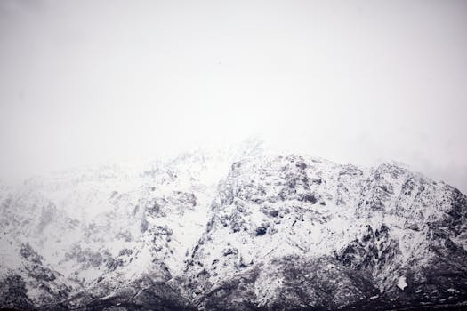 Stunning snow-covered mountain peaks viewed during winter. Ideal for nature and landscape photography.