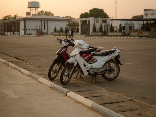 Two motorcycles parked on a street