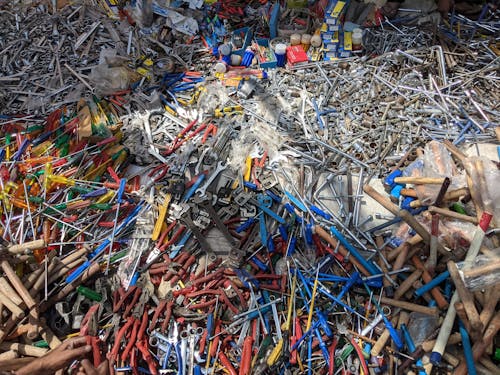 A pile of colorful plastic and metal tools