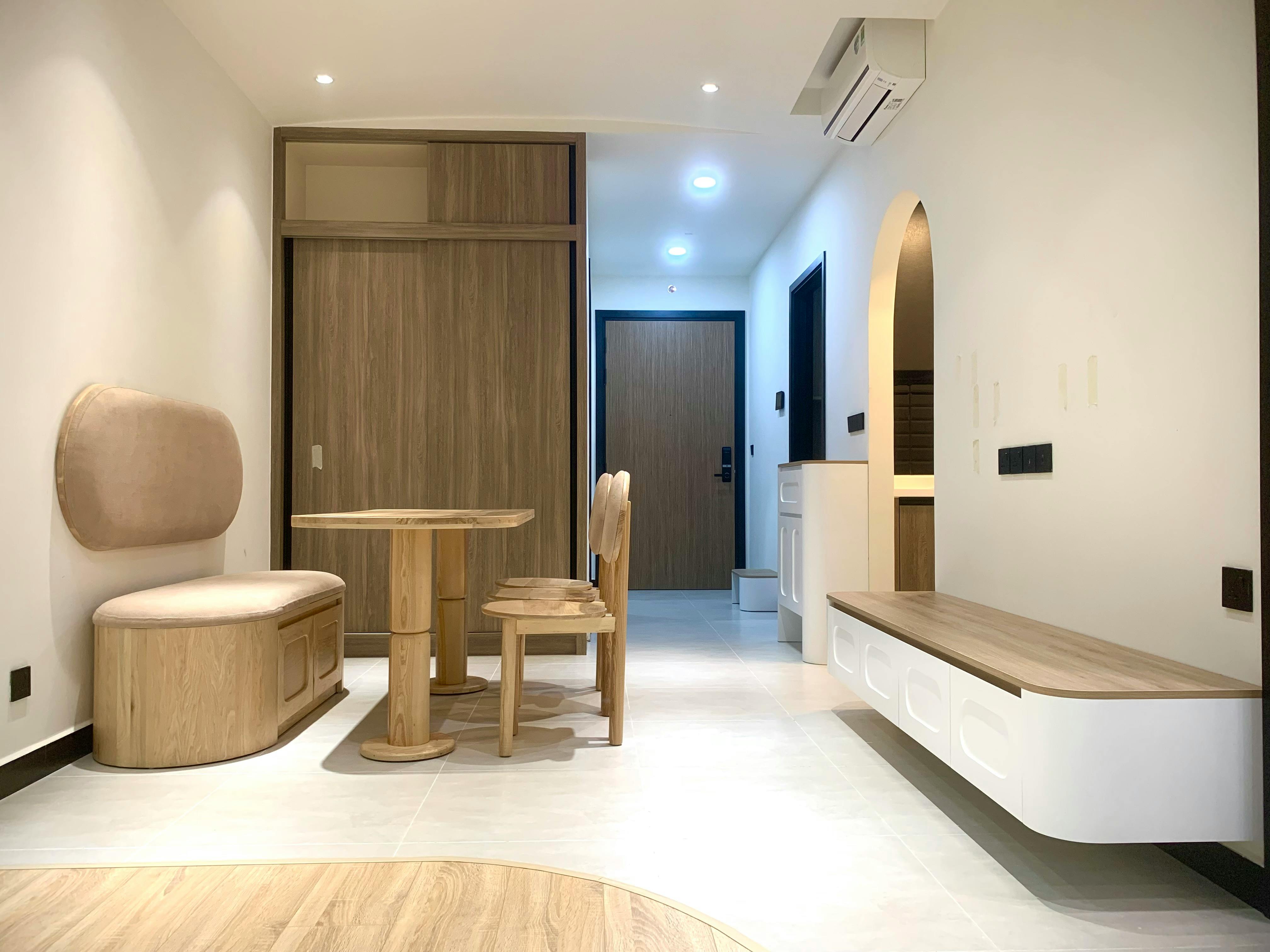 Person using a compact foldable side table in a small apartment with sleek western-style furniture