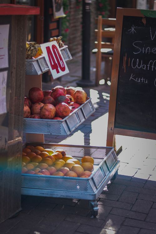 Free Vibrant fruits on sale at an outdoor market stall with price tag sign. Stock Photo