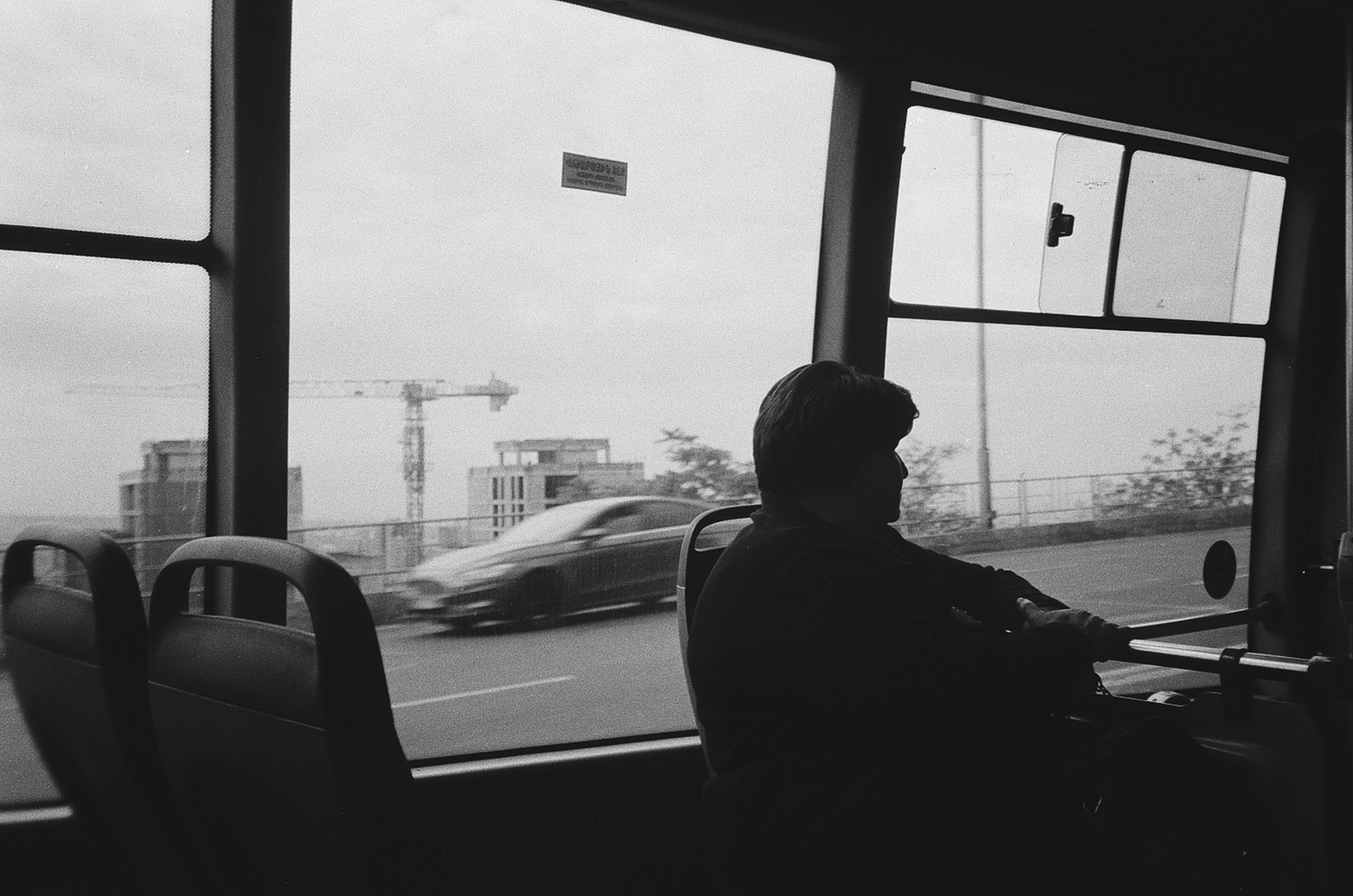 passenger sitting by window in bus