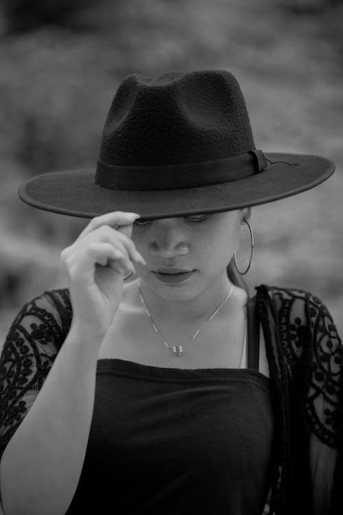Model in a Wide-brimmed Hat and a Chiffon Blouse over a Dress