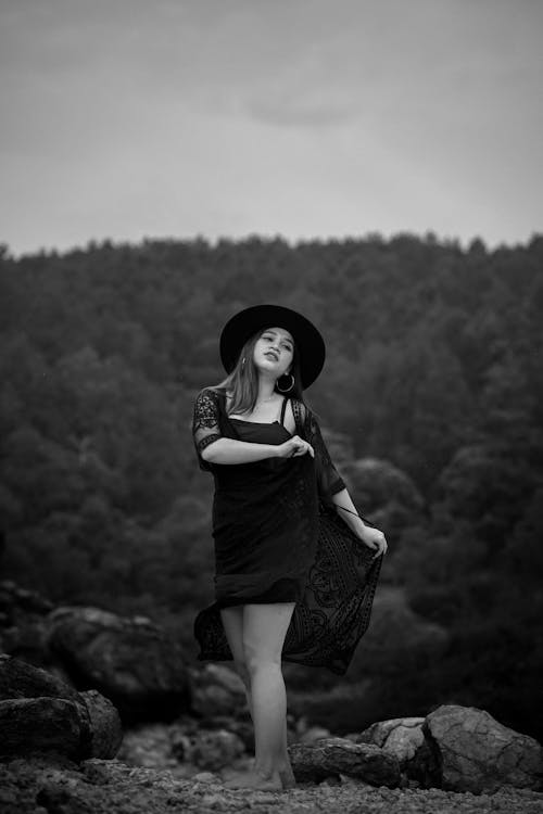 Model in a Mini Dress and a Wide-brimmed Hat Posing in the Mountains