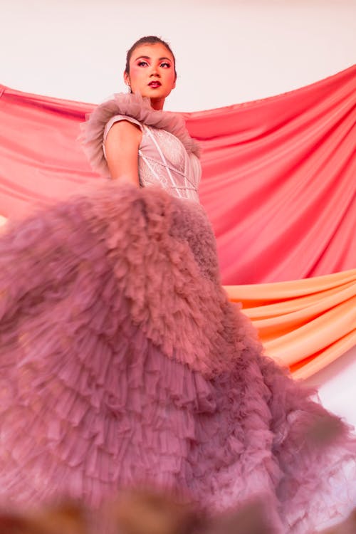 Model in a Pink Ball Gown with Purple Ruffles