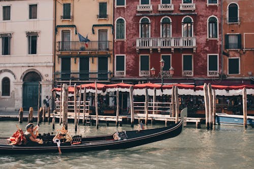 View of a Gondola on the Grand Canal in front of Residential Buildings in Venice, Italy 