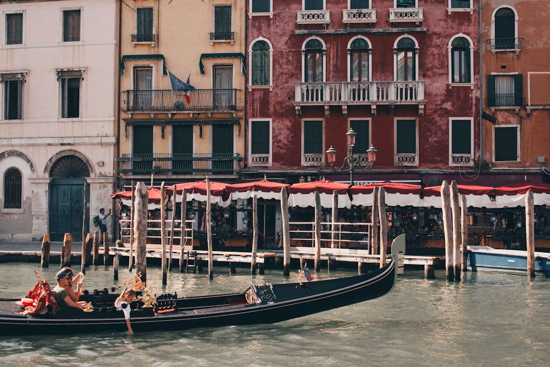 View of a Gondola on the Grand Canal in front of Residential Buildings in Venice, Italy 