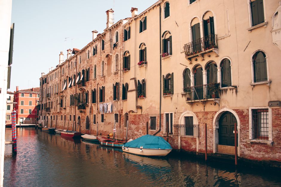 Picturesque canal scene with historic residential buildings in Venice, Italy.