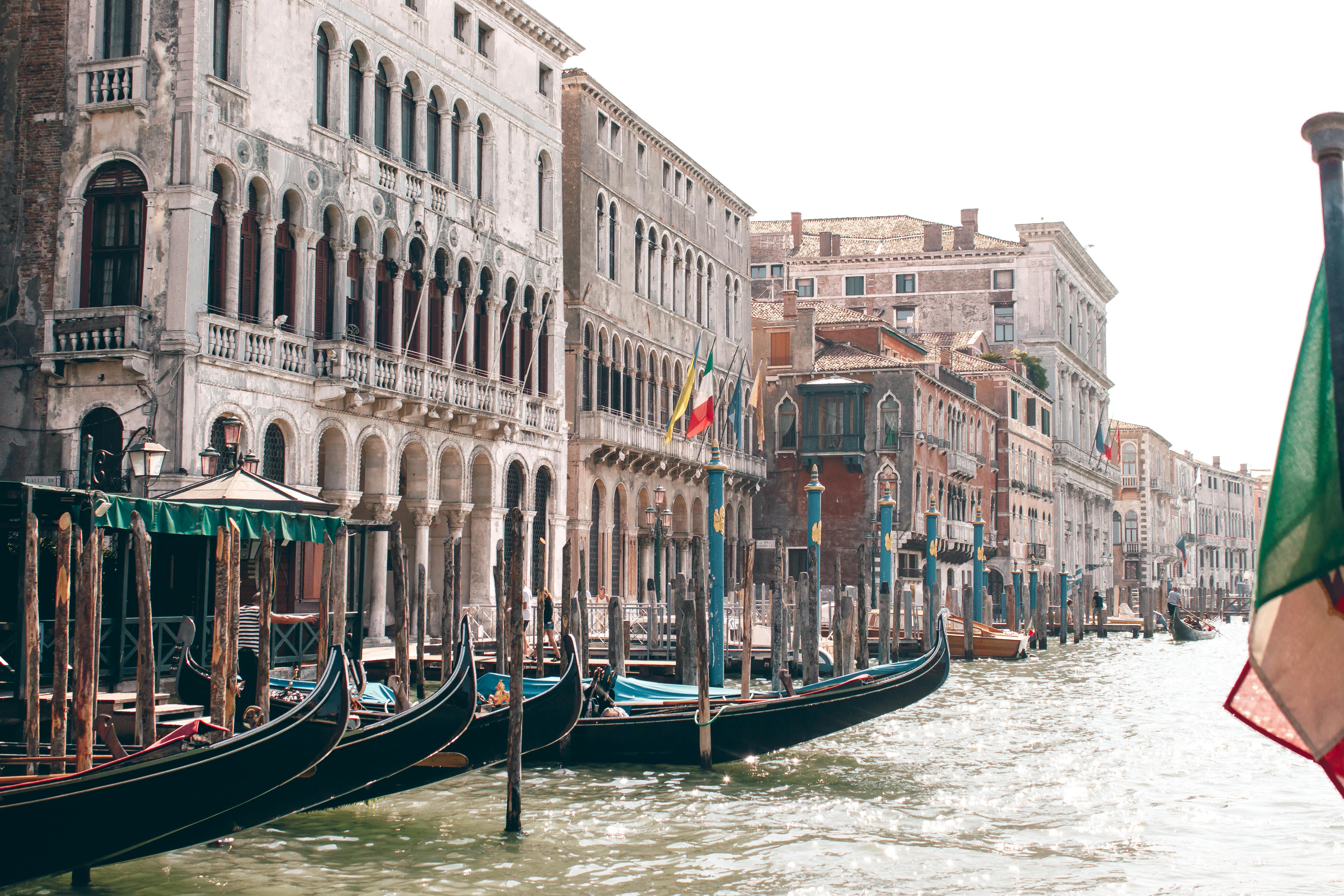 gondolas moored on canal in venice