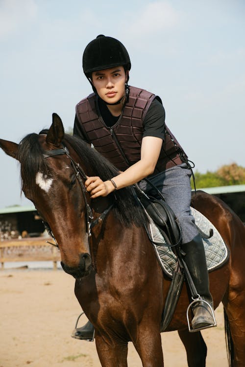 A young man is riding a horse