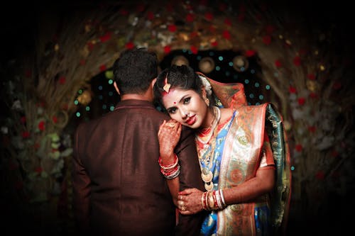 Woman in Traditional Wedding Clothing with Man in Suit 