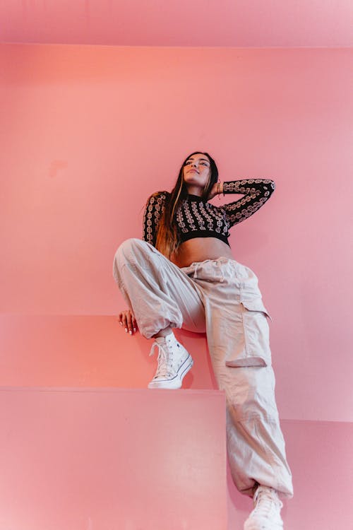 Woman with Long Hair Posing on Pink Background