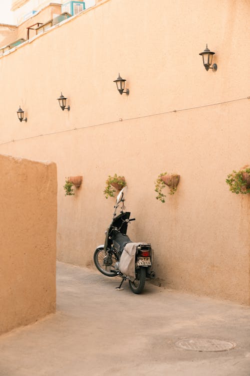 Motorbike Parked by Building Wall