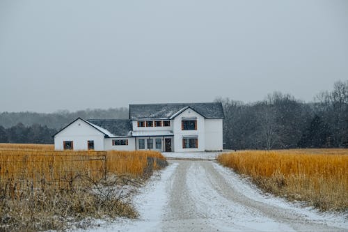 A white house in the middle of a snowy field
