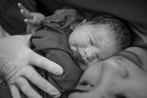 A black and white photo of a newborn baby