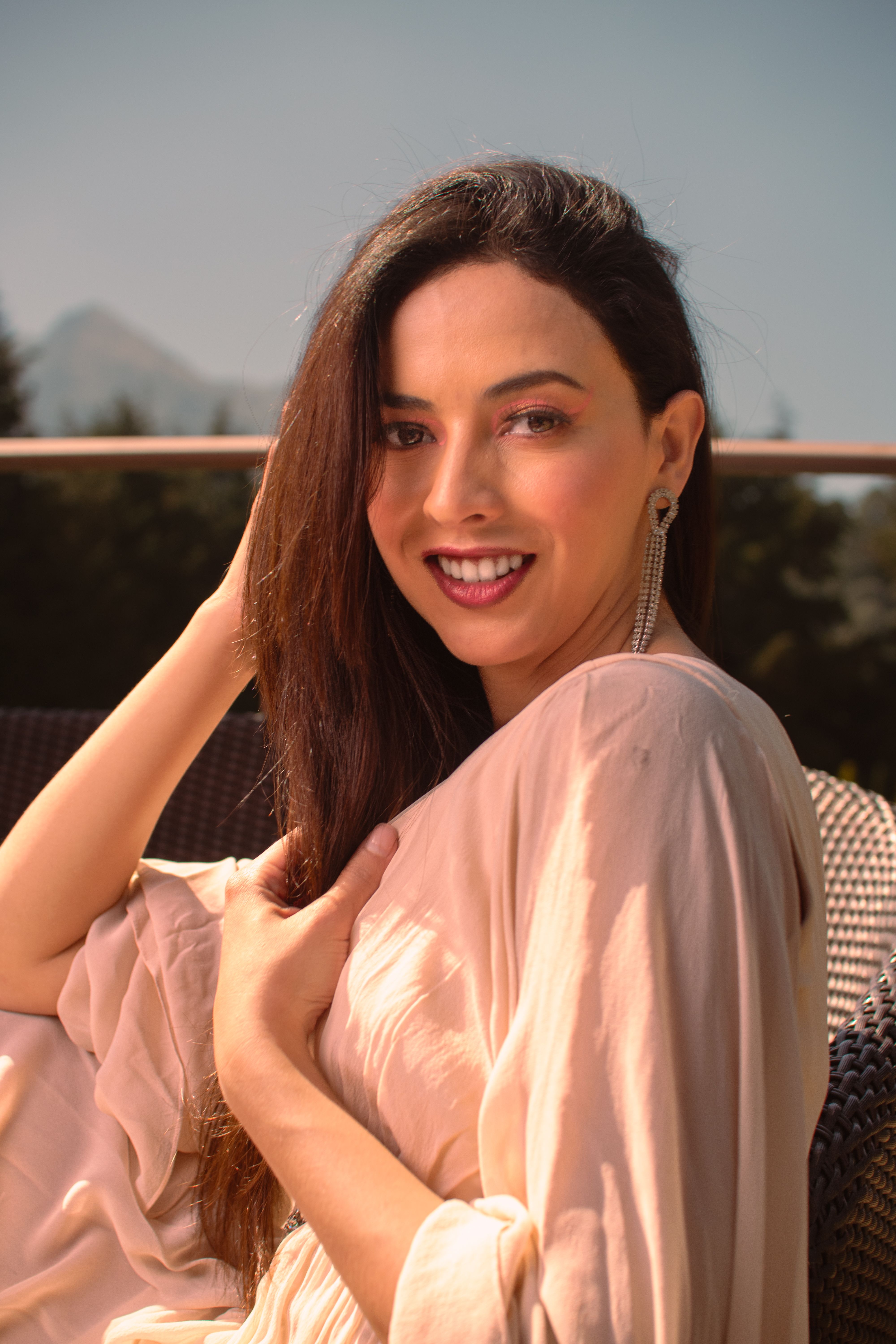 Beautiful Woman in Dress Smiling and Posing on Terrace · Free Stock Photo