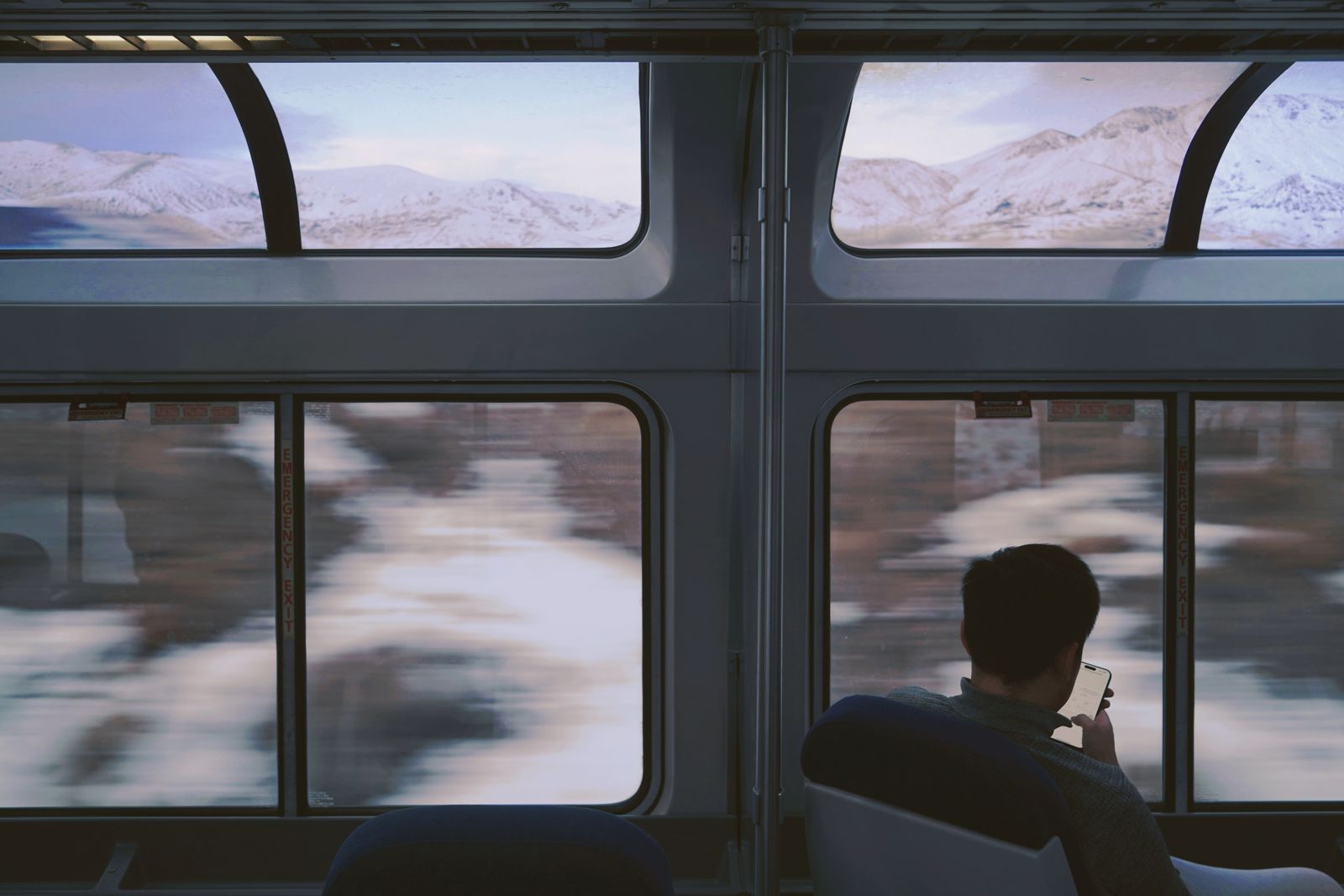 Passenger enjoying a rail journey through large windows
