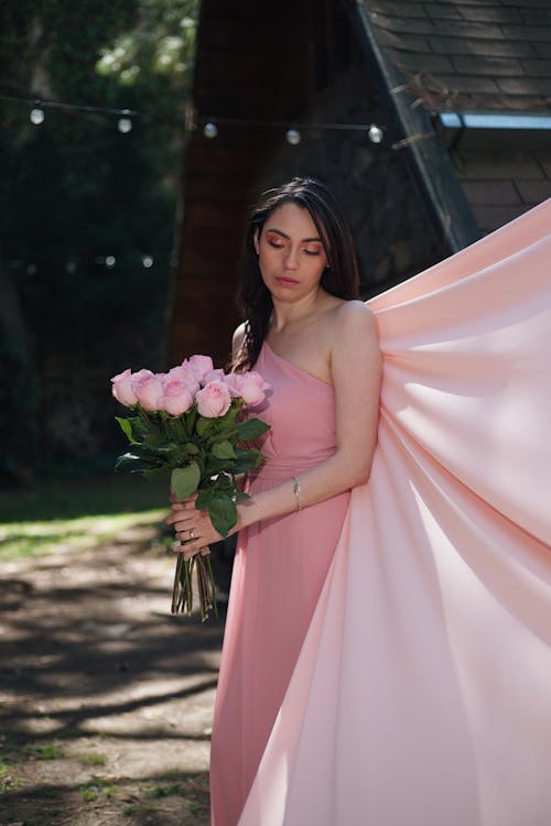 Beautiful Woman in Dress Posing with Pink Roses