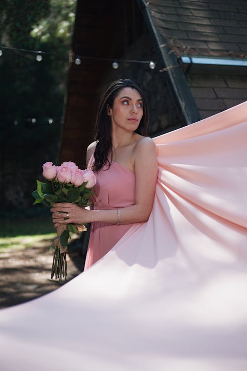 Brunette Woman with Pink Flowers in Ball Gown