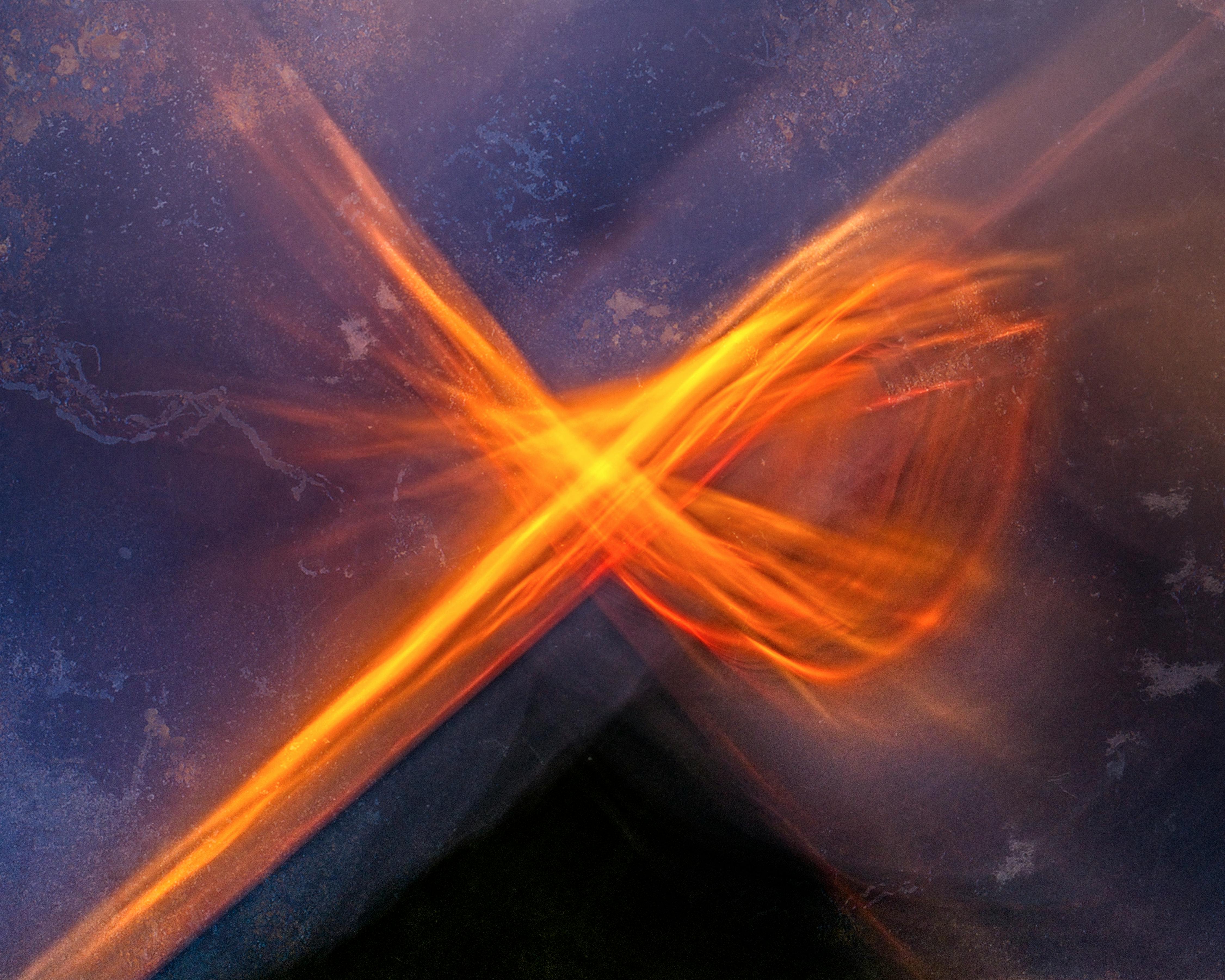 Vivid abstract blurred motion with orange light streaks on a dark backdrop.