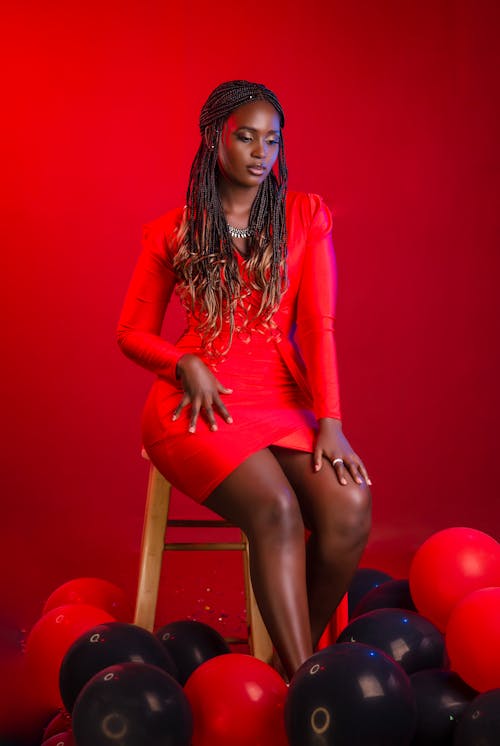 Model in Red Clothes Sitting on Chair