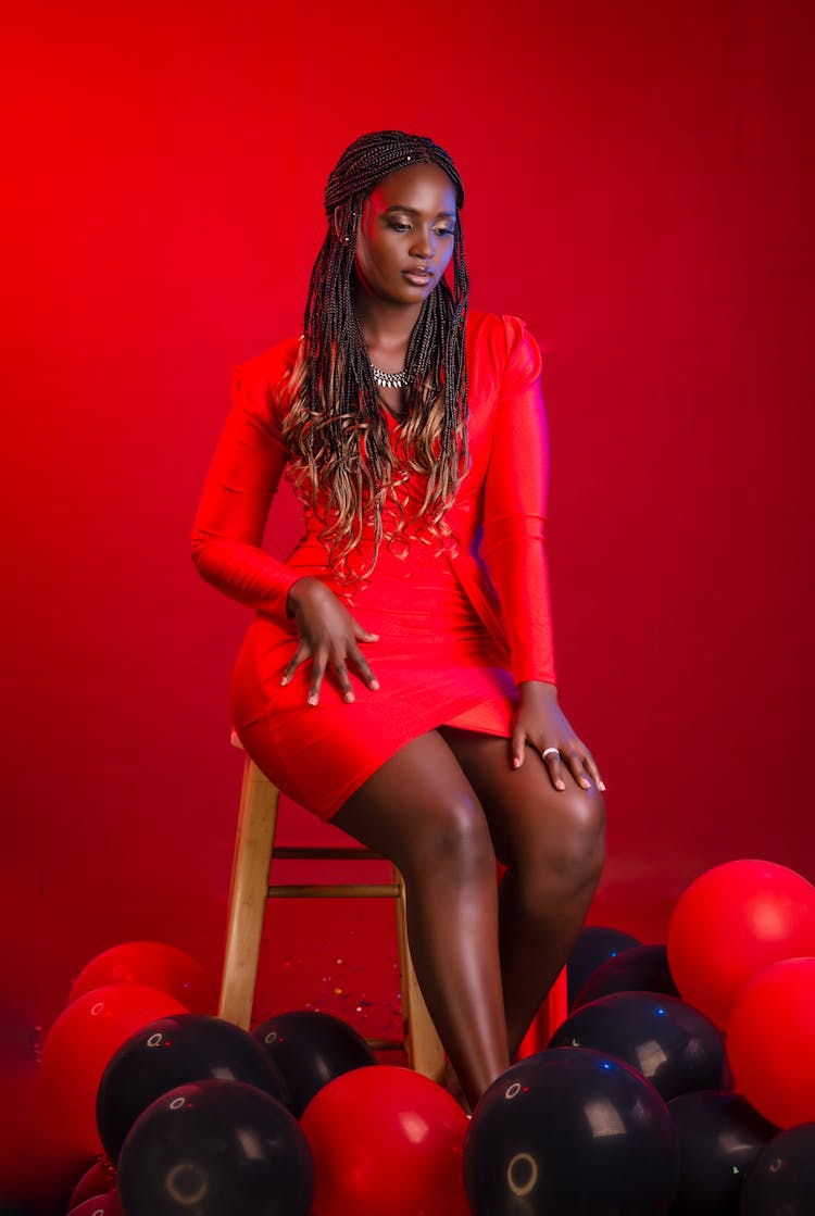 Model In Red Clothes Sitting On Chair