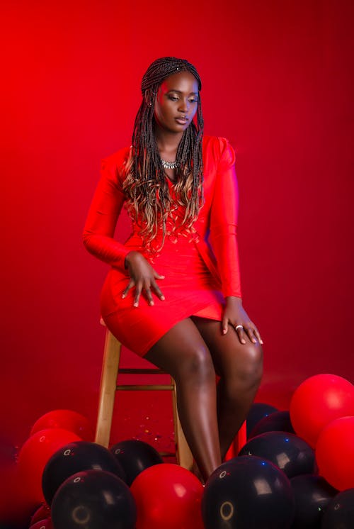 Free Model in Red Clothes Sitting on Chair Stock Photo