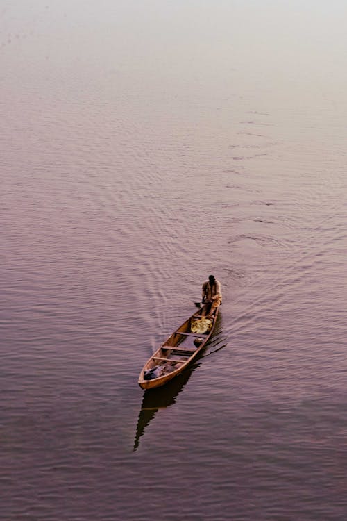 Fisherman on Canoe on Lake