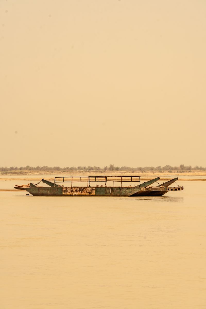 Old rusty ferry on a river, representative of Bali LGA