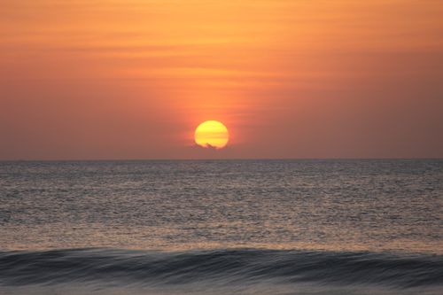 Free A captivating sunset over the ocean captured at the coast of West Java, Indonesia. Stock Photo