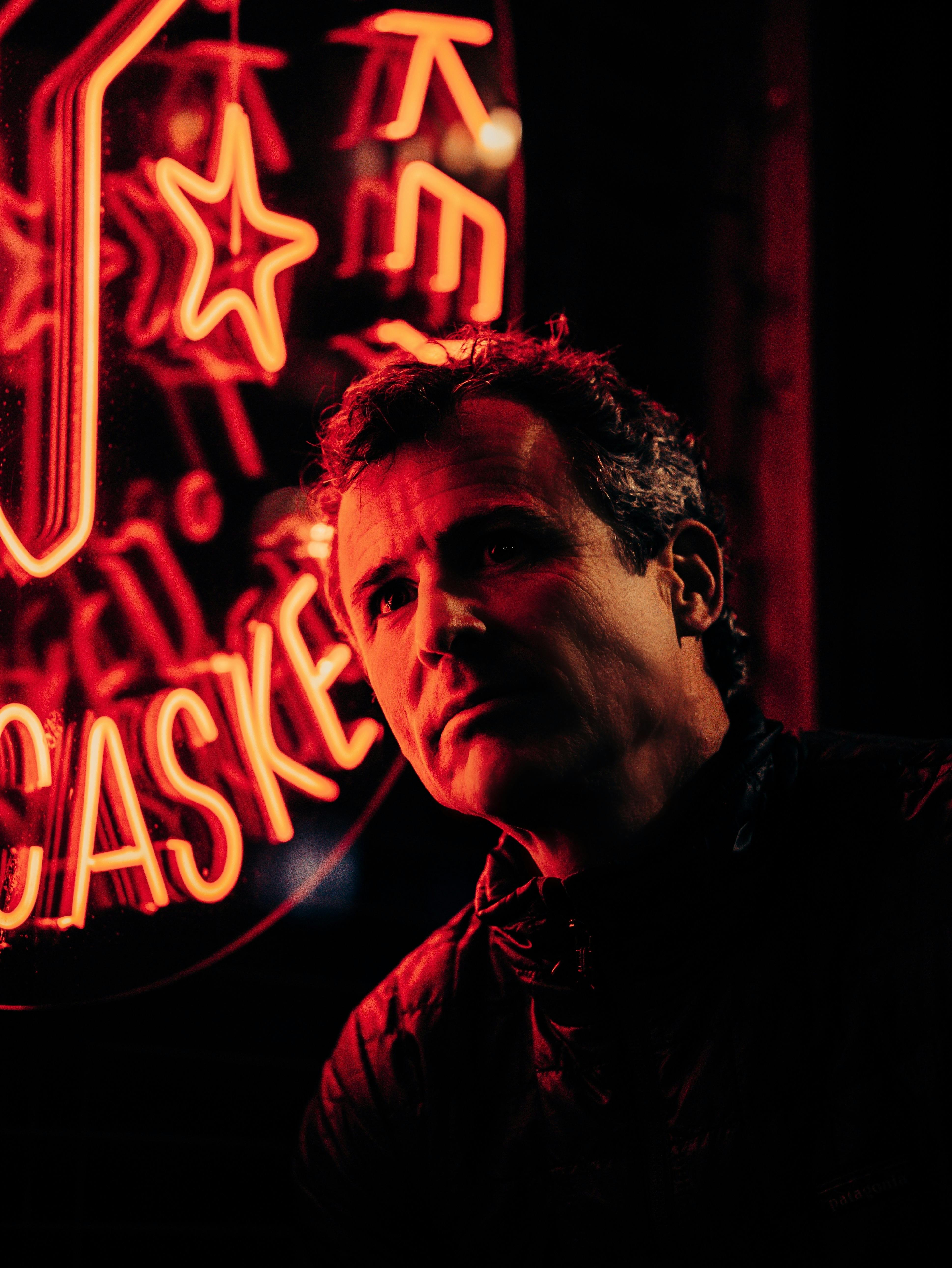 portrait of a man in red lighting neon sign