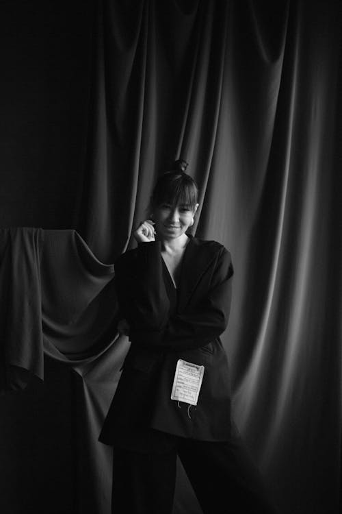 A woman in a black suit posing for a photo
