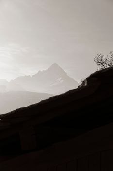 Serene mountain view framed by fog, ideal for nature lovers and mobile wallpapers.