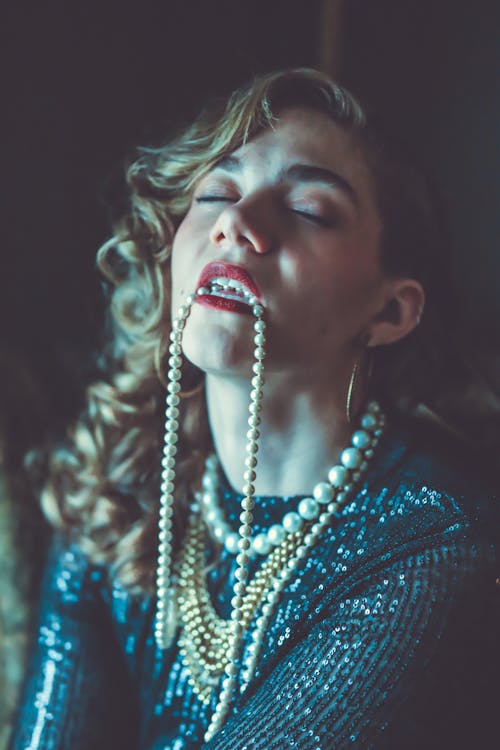 Woman in Pearl Necklaces and Sequined Blue Dress