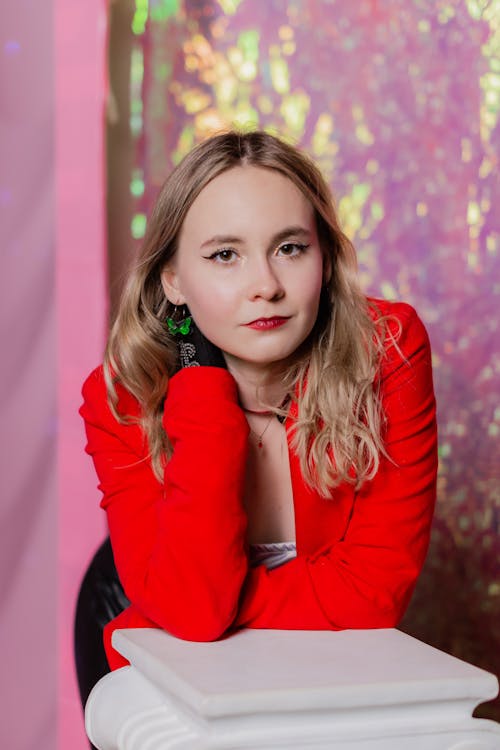 A woman in a red jacket posing for a photo