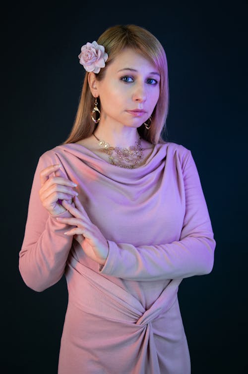 Woman Wearing a Lilac Dress, Posing against Black Background