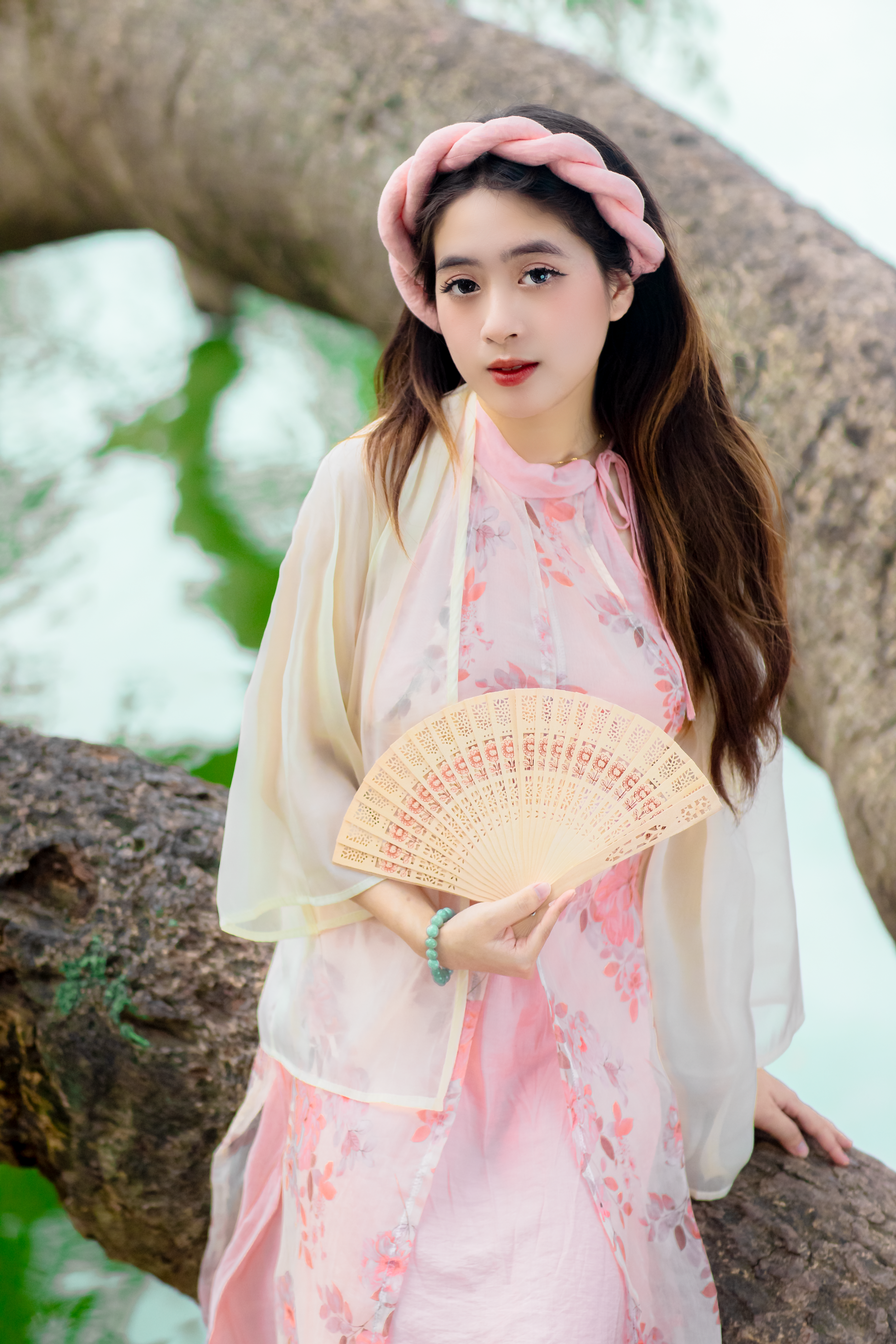 Young Brunette in Pink Dress Posing with Fan · Free Stock Photo