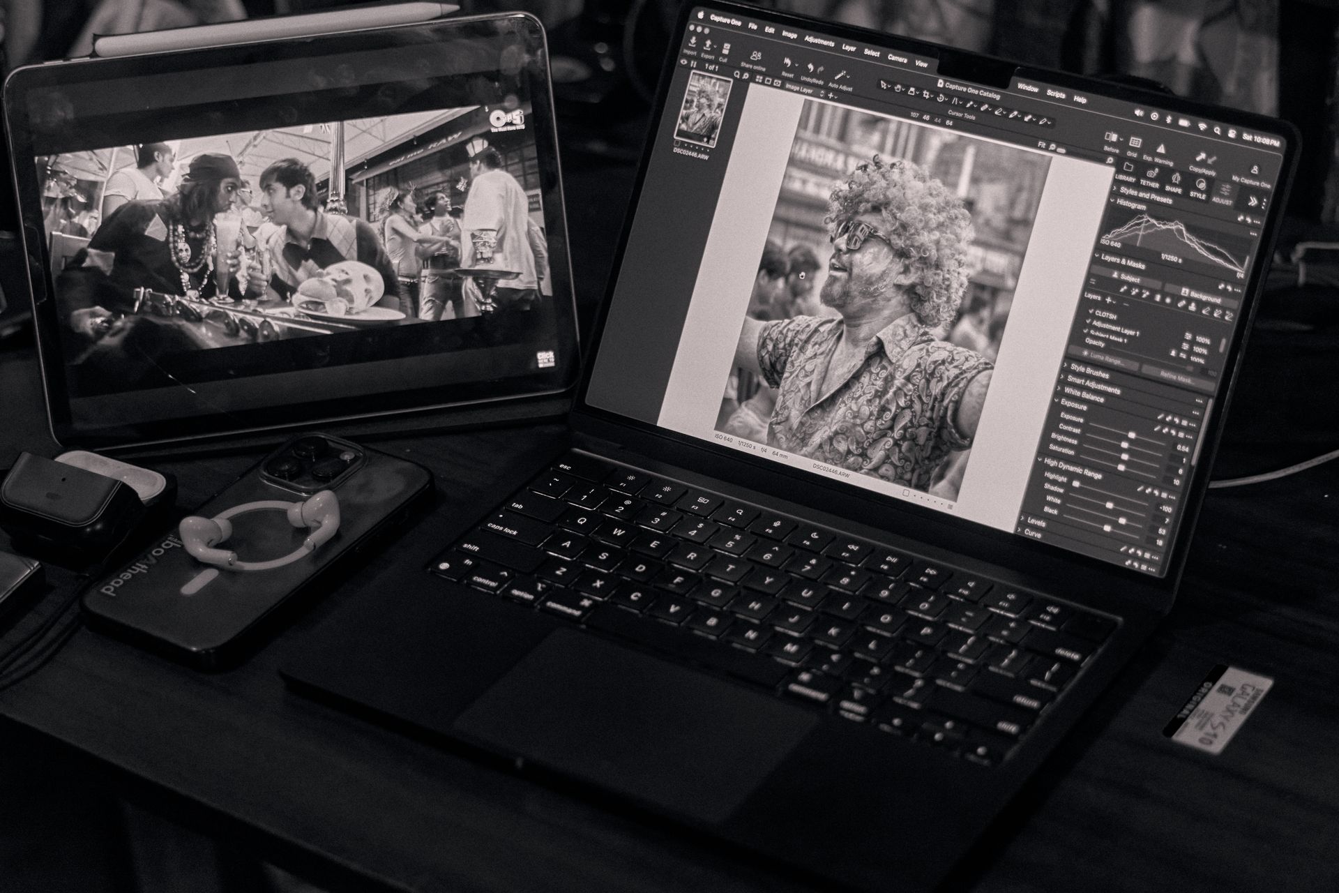 Monochrome setup featuring a laptop and tablet in a creative workspace.