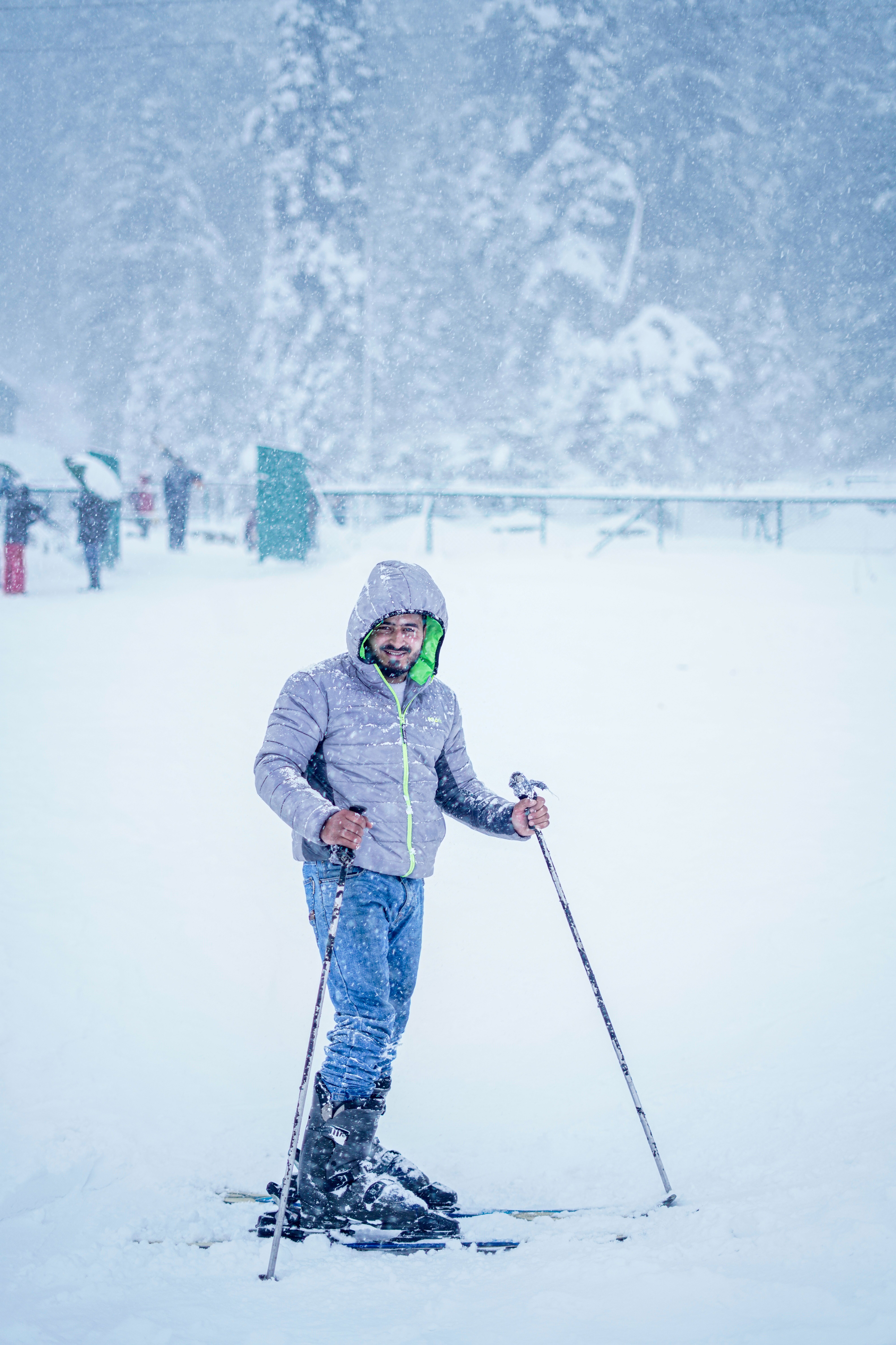 Man skiing in snowy Gulmarg, showcasing winter sports adventure in a picturesque setting.
