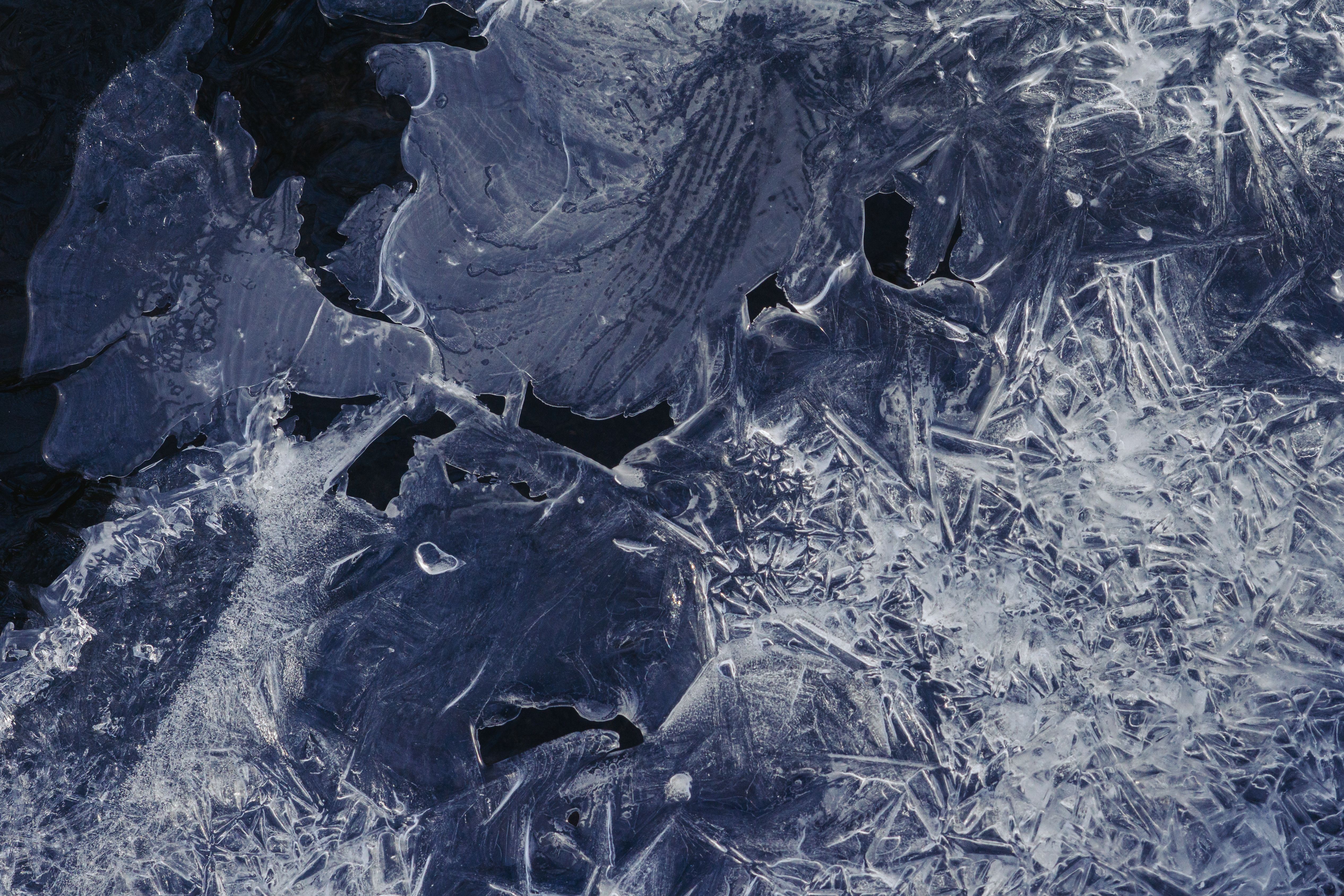 Close-up view of abstract icy texture patterns on a frozen surface showcasing winter's natural artistry.