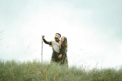 Couple Hugging on Grassland