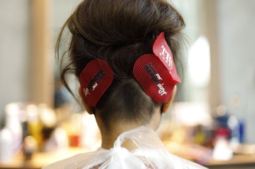 A woman with red hair clips on her head