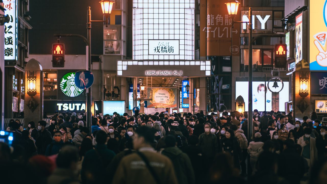 crowded dotonbori street in osaka at night bustling with people vibran