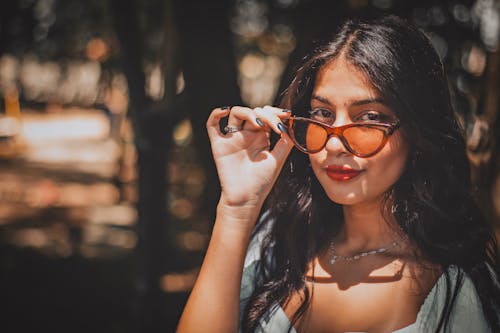 A woman wearing sunglasses in the woods