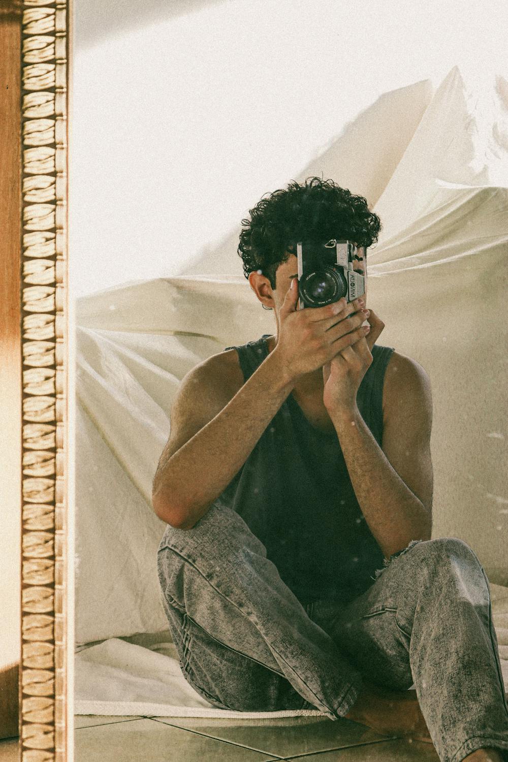 Man Photographing his Reflection in Mirror · Free Stock Photo