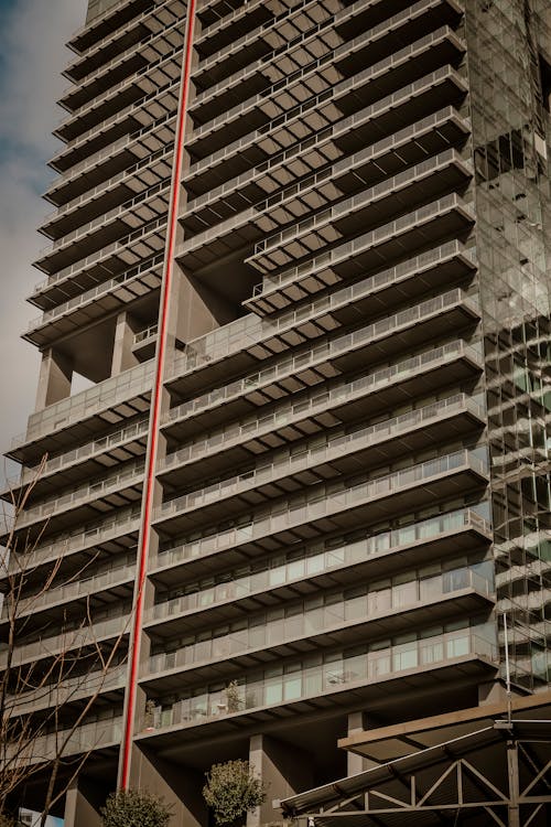 Glass Residential Skyscraper with Balconies and Red Line on Facade