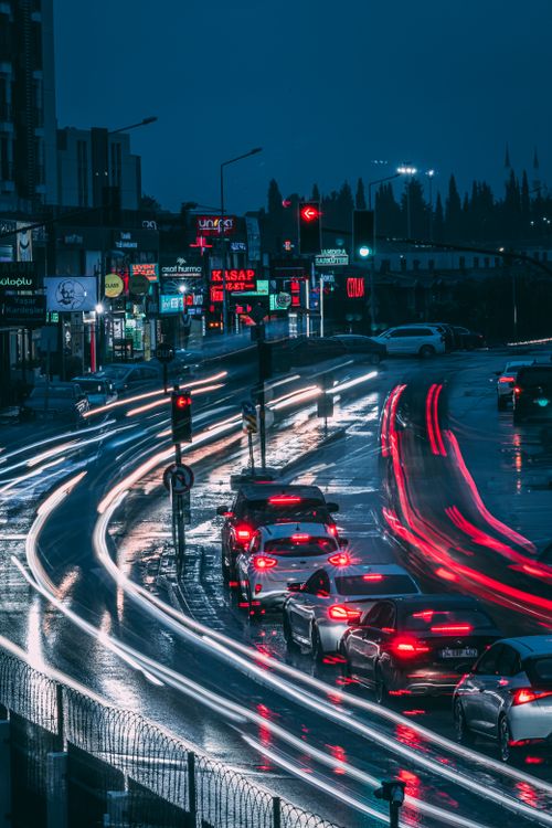 Free Vibrant city street traffic with long exposure light trails at night. Stock Photo