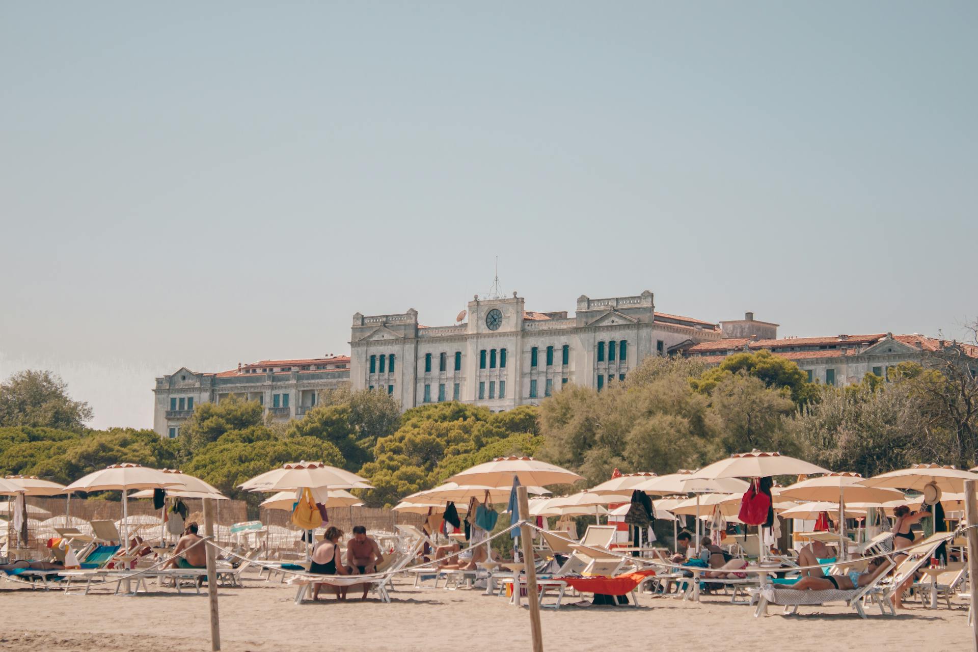 Enjoy a sunny day at the beach with the iconic Grand Hotel Des Bains in Venice, Italy.