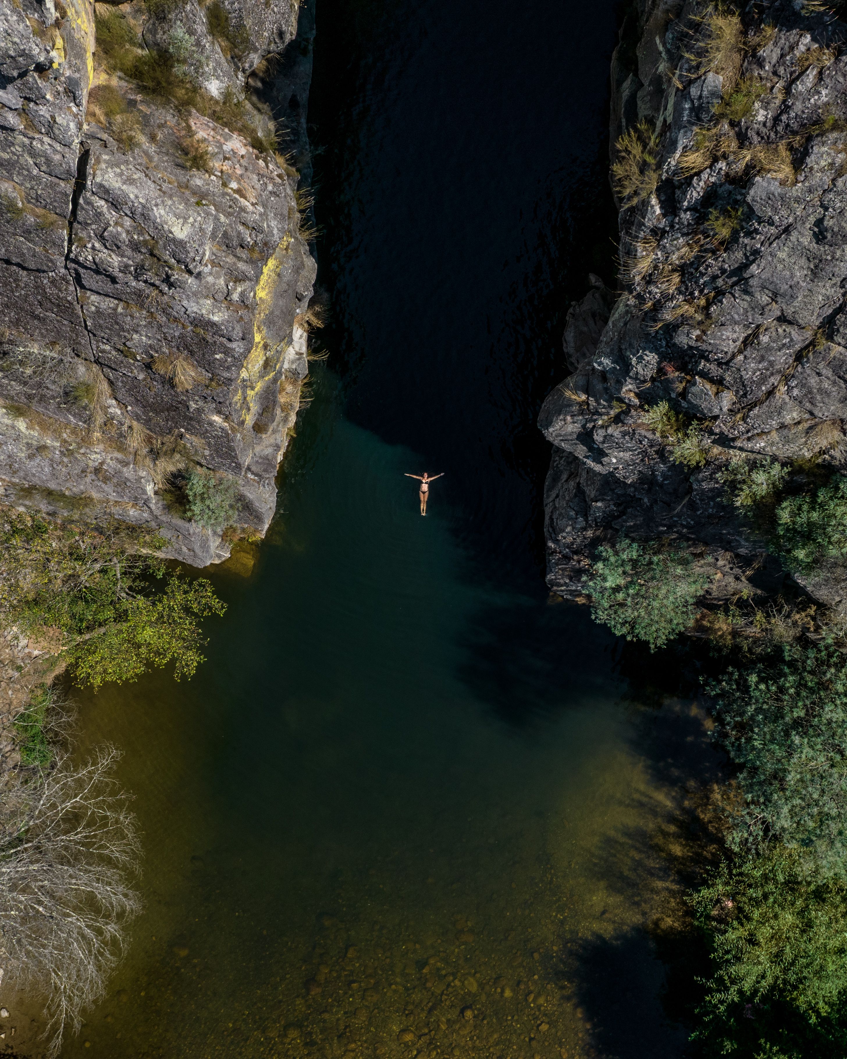 Woman Swimming on a Stream Among Rocks · Free Stock Photo